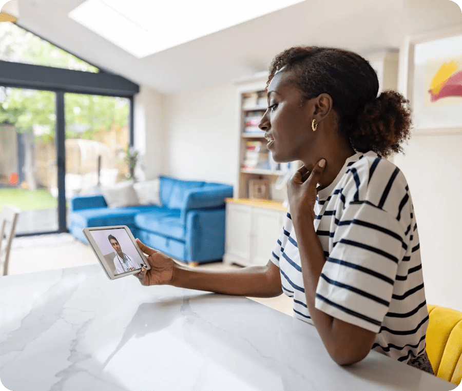 Woman video chatting on a tablet at home.